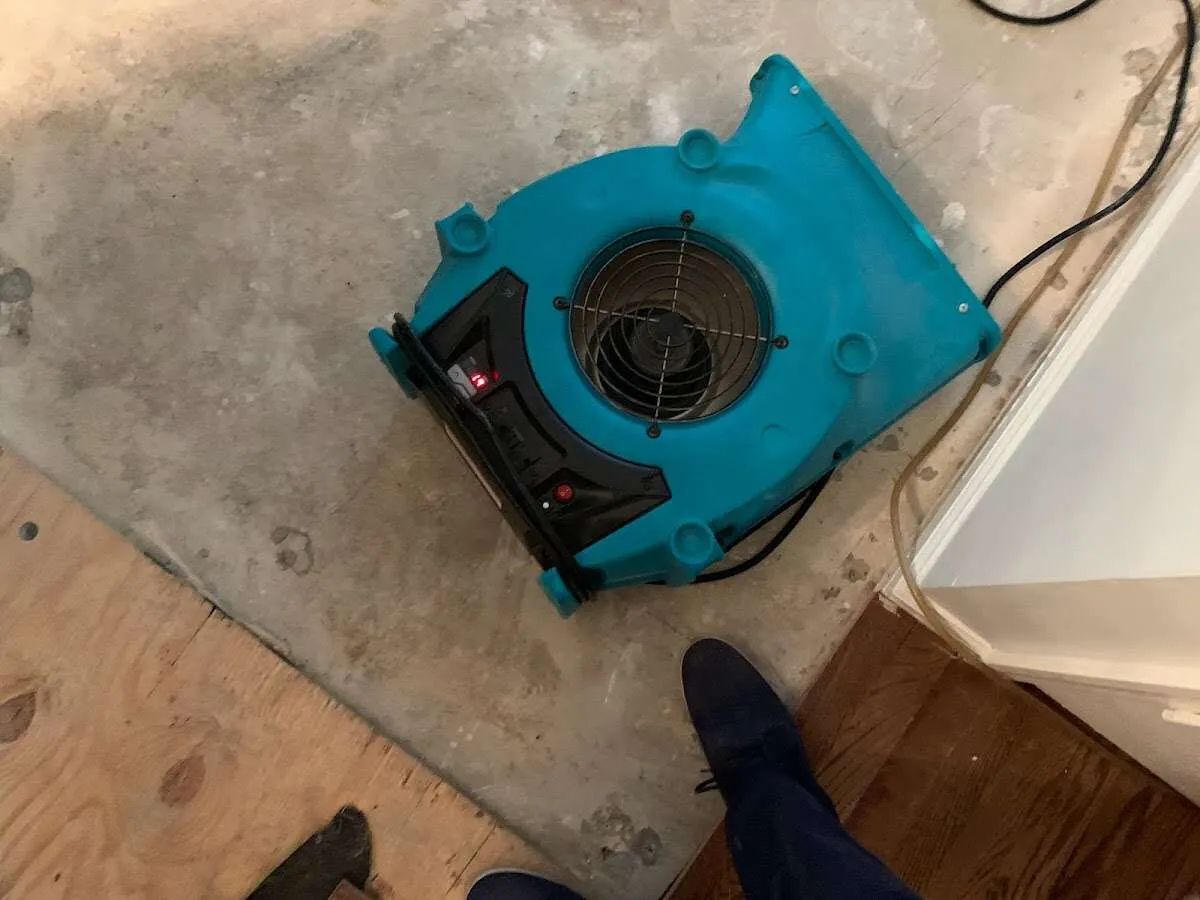 Air mover drying subfloor during Commercial Water Damage Restoration in Stockton